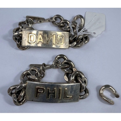 593 - A hallmarked silver pair of heavy identity bracelets with raised yellow metal names:  David & Phil, ... 