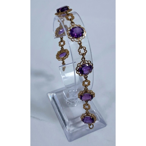 622 - A 9 carat hallmarked gold filigree bracelet set amethyst coloured stones, gross weight 11.7 gm