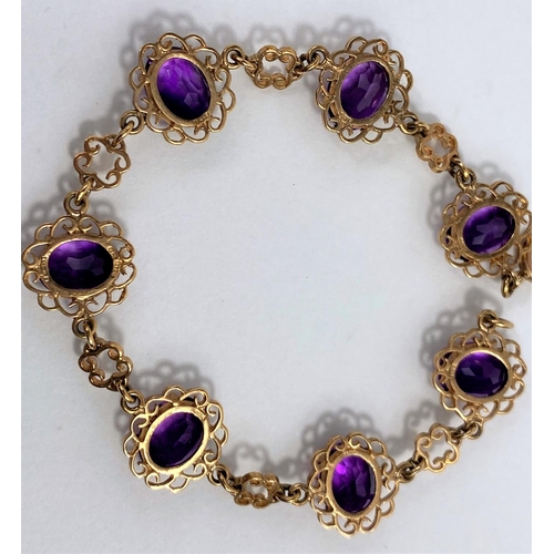 622 - A 9 carat hallmarked gold filigree bracelet set amethyst coloured stones, gross weight 11.7 gm