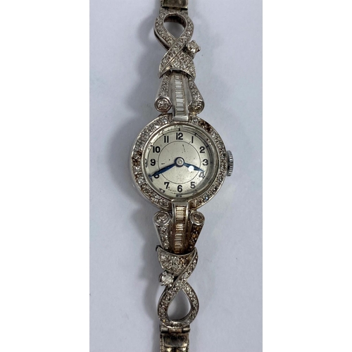 625 - A 1930's ladies white metal cocktail watch, the bezel and ornate shoulders set baguette and graduati... 