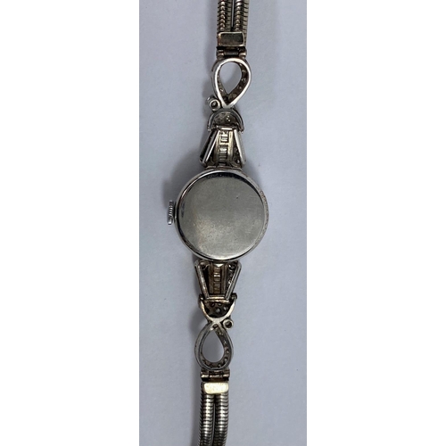 625 - A 1930's ladies white metal cocktail watch, the bezel and ornate shoulders set baguette and graduati... 