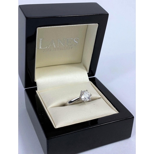 629 - A solitaire diamond dress ring on a white metal shank, stamped 750, set with brilliant cut diamond, ... 