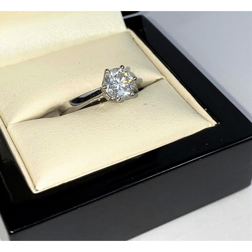 629 - A solitaire diamond dress ring on a white metal shank, stamped 750, set with brilliant cut diamond, ... 