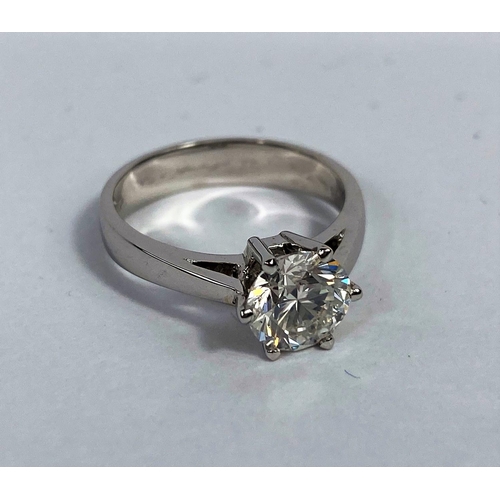 629 - A solitaire diamond dress ring on a white metal shank, stamped 750, set with brilliant cut diamond, ... 