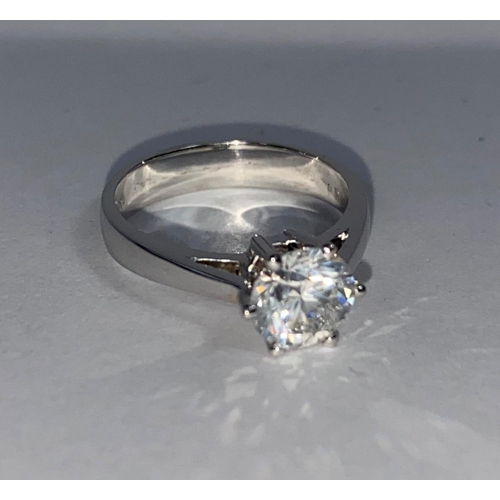 629 - A solitaire diamond dress ring on a white metal shank, stamped 750, set with brilliant cut diamond, ... 