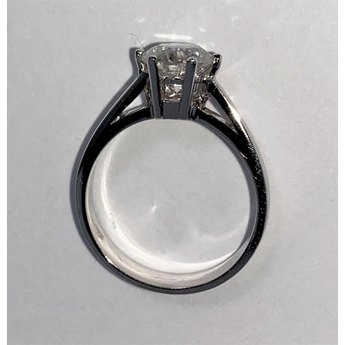 629 - A solitaire diamond dress ring on a white metal shank, stamped 750, set with brilliant cut diamond, ... 