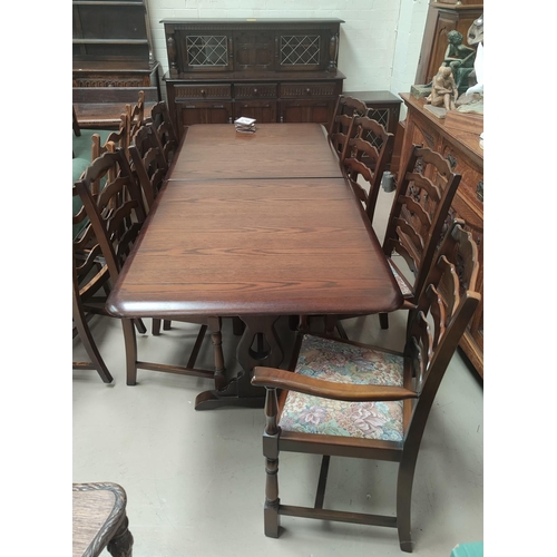 717 - A Priory period style oak dining suite comprising extending table, 8 chairs (6 + 2), and court cupbo... 