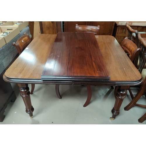 716 - A Victorian mahogany wind out dining table with rounded rectangular top, with 1 leaf and winding han... 