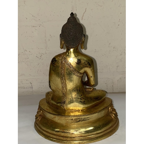 361 - A Chinese bronze gilded figure of a buddha in lotus position, ht. 23cm