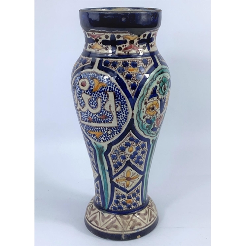 387 - A Persian style tall vase decorated in the traditional manor. Height 31cm
2 glaze chips at foot othe... 