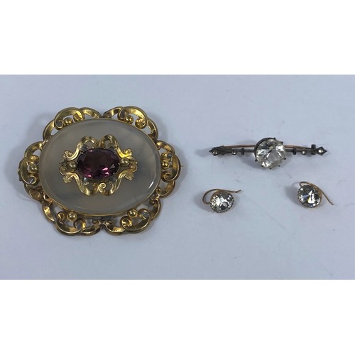 557 - A Victorian large ornate gilt metal brooch set amethyst coloured stone; a bar brooch set large clear... 