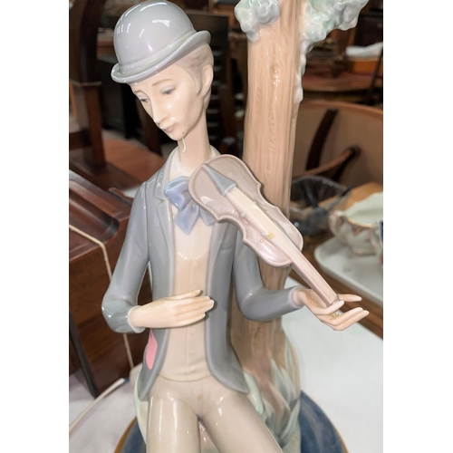 453 - A Lladro group:  violinist by a tree (violin a.f.)