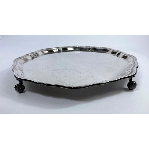 548 - A hallmarked silver circular salver with wavy rim, on circular scroll feet, Sheffield 1951, diameter... 