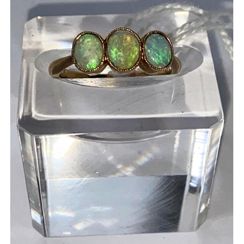 554 - A yellow metal ring set 3 opals, stamped '18ct', 2.6 gm
size M.