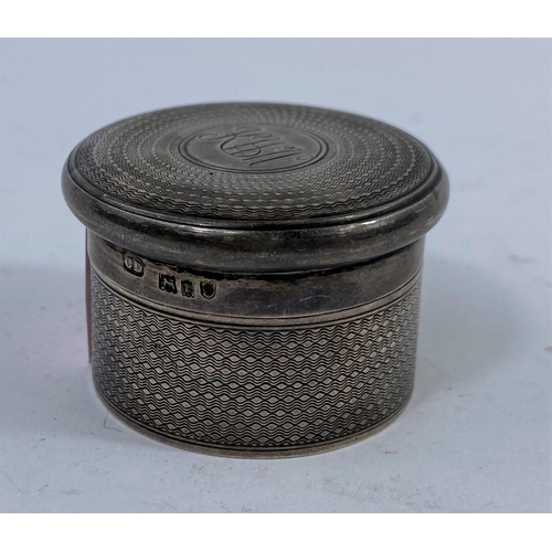 598 - A hallmarked silver pill box, monogramed engine turned, London 1910.