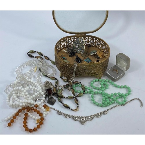 634 - A small selection of costume jewellery in gilt casket including a gold ring shank etc