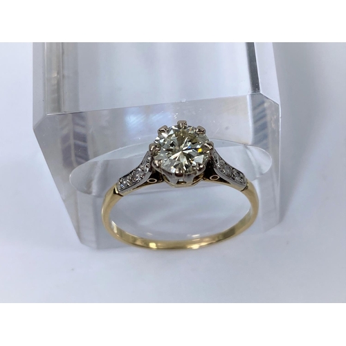 564 - A yellow metal ring set diamond solitaire stone of 1.10 metric carat approx, each shoulder set 3 sma... 