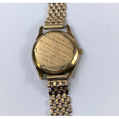 565 - A gent's wristwatch by Garrard, 9 carat hallmarked gold on 9 carat hallmarked gold bracelet strap (b... 