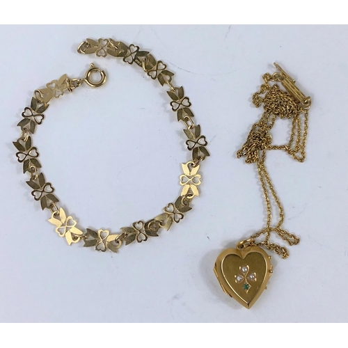 626 - A bracelet with yellow metal heart and butterfly wing links, stamped 375; a heart locket pendant set... 