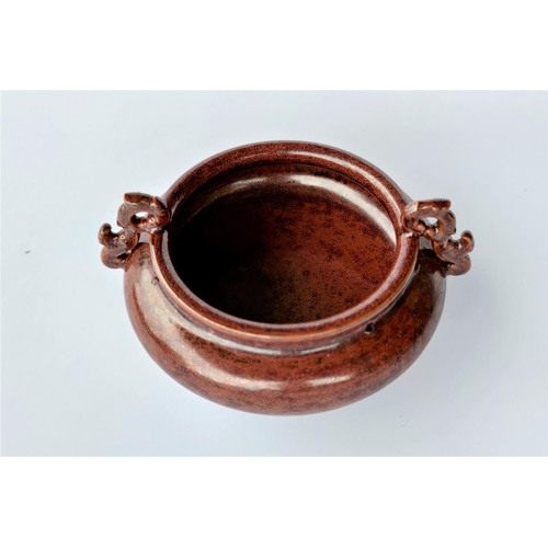 301A - A Chinese burnt orange coloured sensor with three feet and two handles; Diameter:12cm