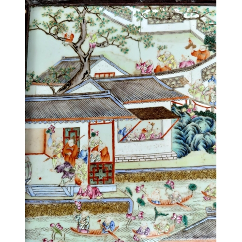 390A - A large Chinese ceramic tile with polychrome decoration of a busy festival scene with musicians, boa... 