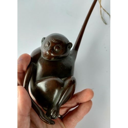 390E - A bronze hanging pot in the form of a monkey (a.f.) & 4 other items of metalware. (the monkey on the... 