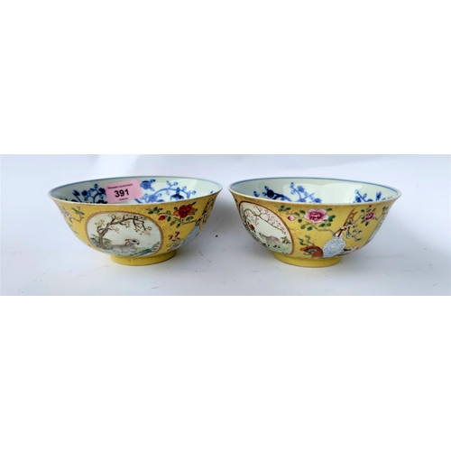 391 - Apair of Chinese yellow glaze bowlswith exterior panels depicting vases and animals, blue and white ... 