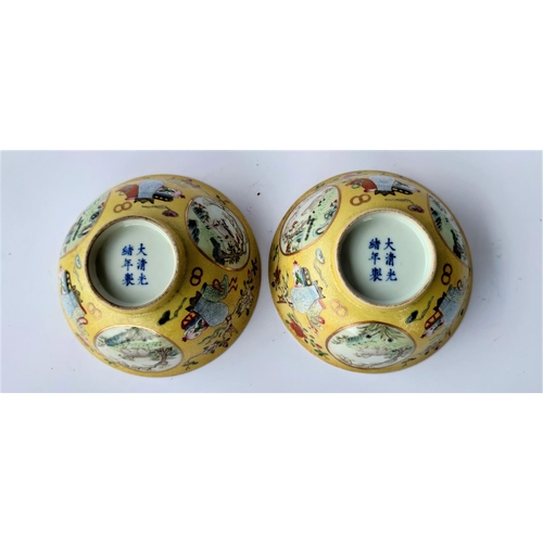 391 - Apair of Chinese yellow glaze bowlswith exterior panels depicting vases and animals, blue and white ... 