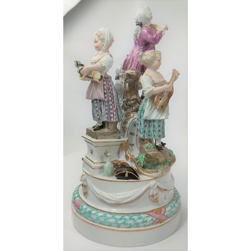 472D - A Meissen figural group centre piece of 4 musicians, 2 males, 2 females attop a pierced stand, cross... 