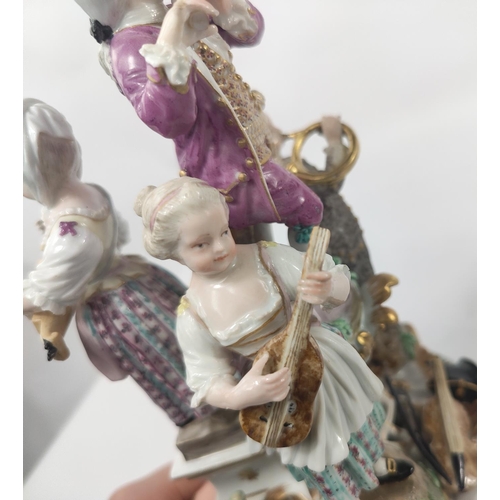 472D - A Meissen figural group centre piece of 4 musicians, 2 males, 2 females attop a pierced stand, cross... 