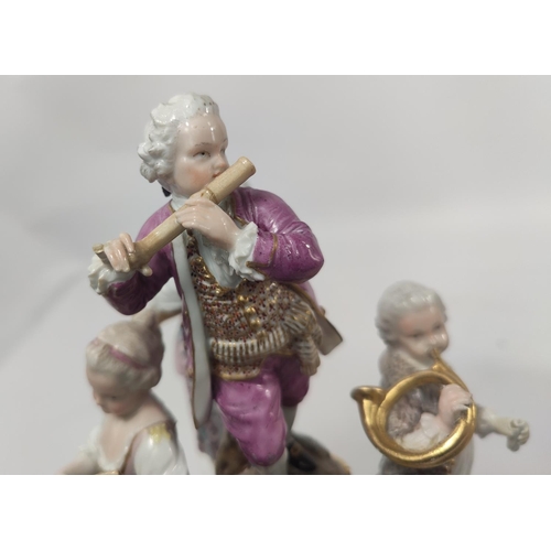 472D - A Meissen figural group centre piece of 4 musicians, 2 males, 2 females attop a pierced stand, cross... 