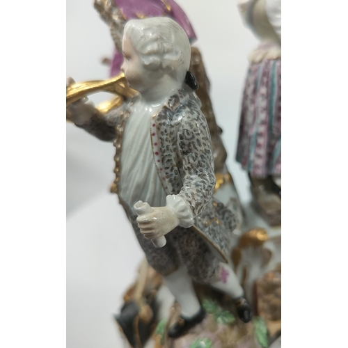 472D - A Meissen figural group centre piece of 4 musicians, 2 males, 2 females attop a pierced stand, cross... 