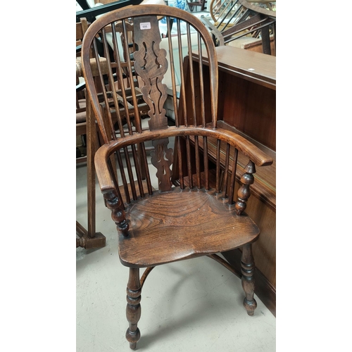 686 - A 19th century elm Windsor armchair with high back and crinoline stretcher, on turned legs