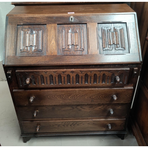 694 - A reproduction oak bureau with linen fold carving, fall front and 4 drawers

Height 93cm, depth 40cm... 