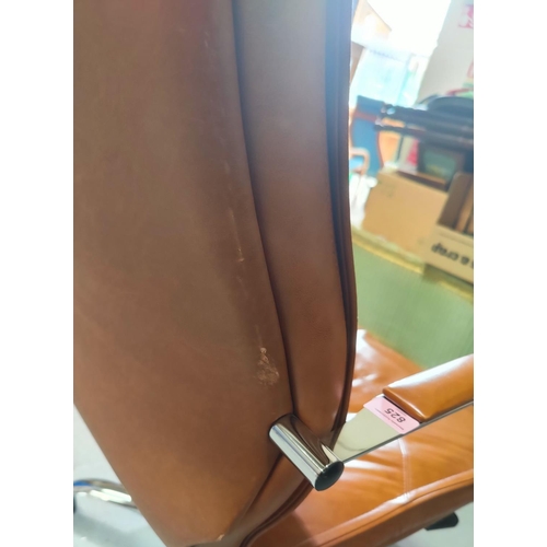 825 - A tubular chrome framed armchair in tan leather
