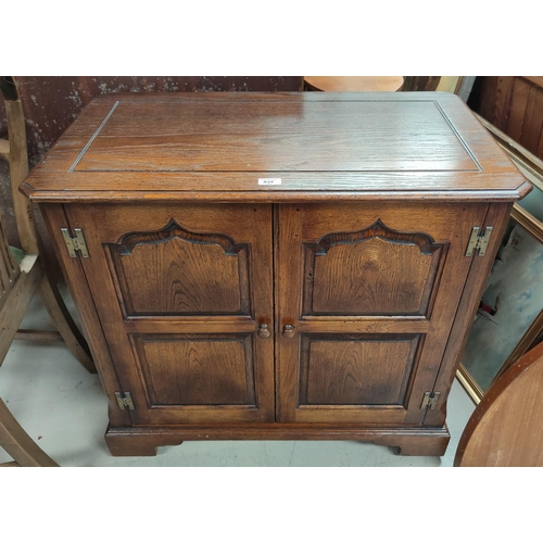 834 - A distressed oak hostess cabinet in 18th century style case by Titchmarch and Goodwin