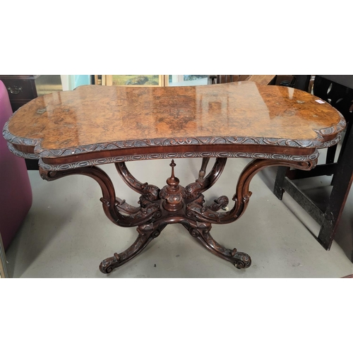 835 - A victorian shaped rectangular quarter veneered burr walnut centre table on carved scroll supports, ... 