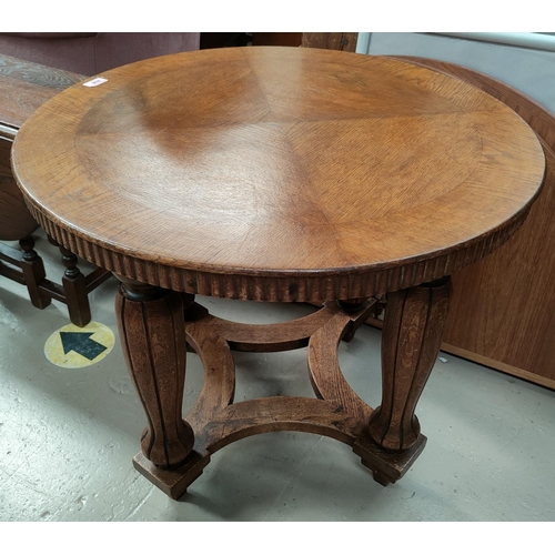 838 - An oak circular table with bulbous legs with squared support ridged edge