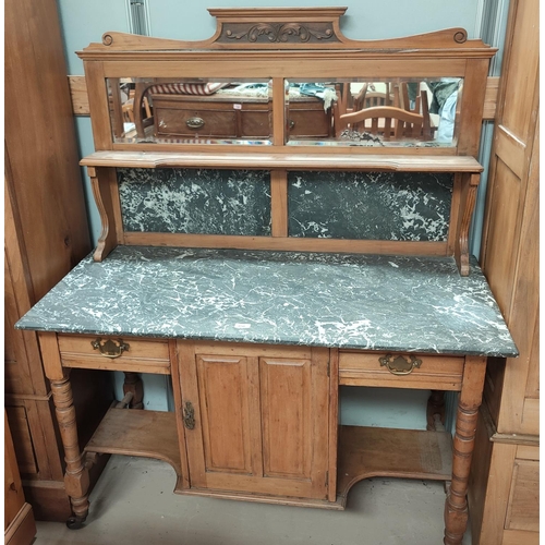 850 - A stripped wood, marble top wash stand with tall mirror back and single cupboard below.