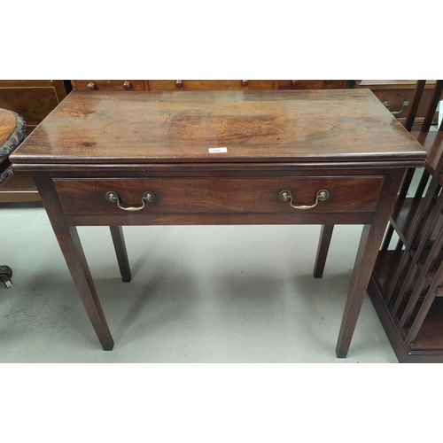 755 - A Georgian mahogany fold-over tea table with square end