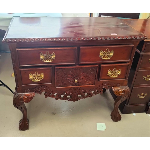 775 - A reproduction carved stained wooden chest with five drawers on ball and claw feet h82 x d48 x L90cm