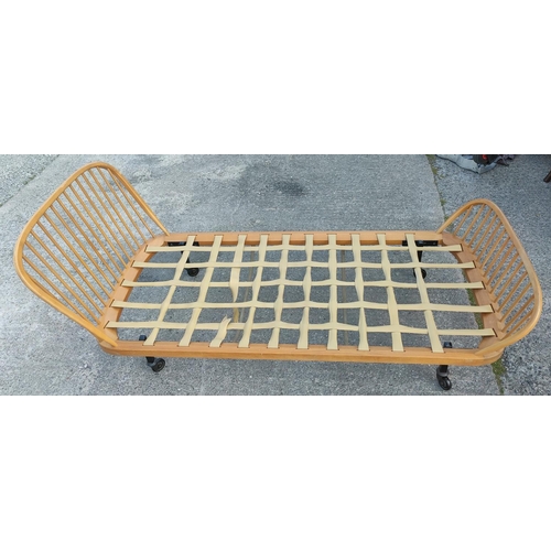 839 - A pair of light wood vintage Ercol stick head and foot single day beds.