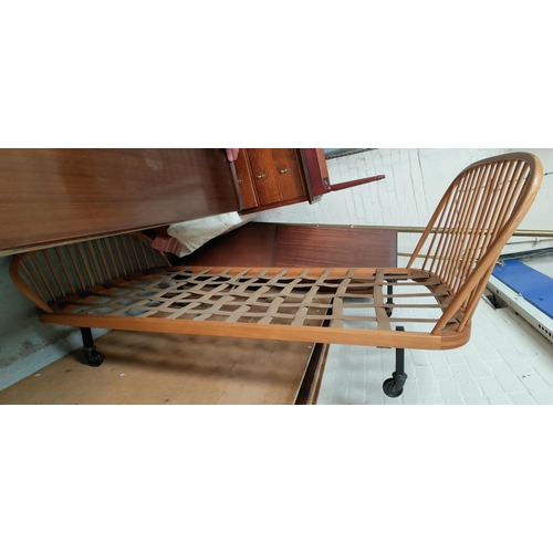 839 - A pair of light wood vintage Ercol stick head and foot single day beds.