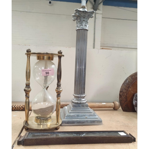 90 - A chromed Corinthian column table lamp; a brass framed hourglass; a thermometer