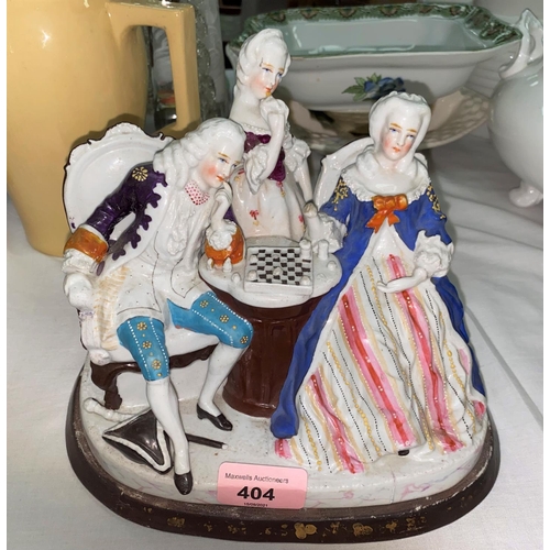 404 - A Dresden style china two bottle ink stand, the cover in the form of figures playing chess, length 7... 