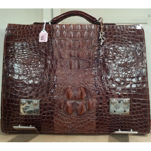 102 - A Crocodile skin attache case with internal compartments and chrome fasteners marked HWA CHENG.  41c... 