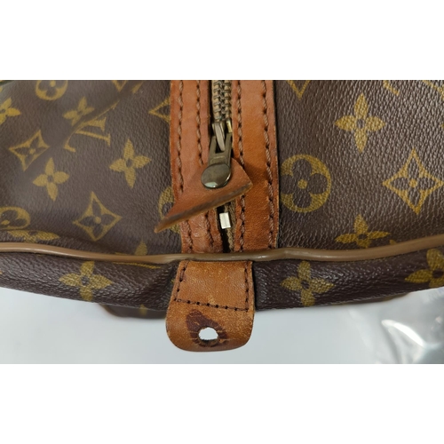 72 - A Louis Vuitton 'sacsouple'/keepall, monogrammed, with tan leather strapping and handles, zip tab em... 
