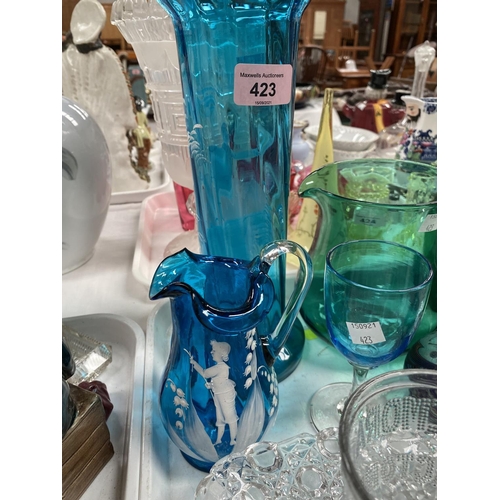 423 - A Victorian blue glass vase and jug decorated in the Mary Gregory style, heights 27