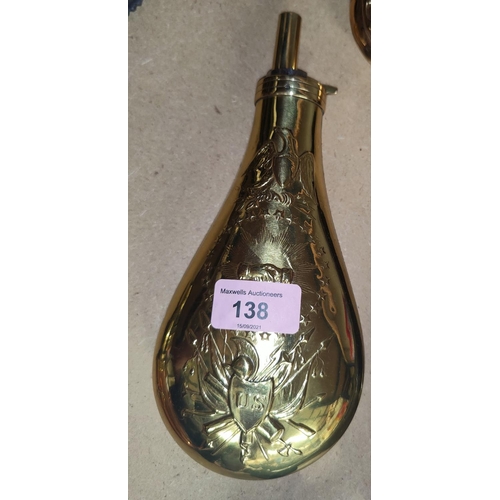 138 - A large American brass powder flask with embossed trophy and eagle, 23cm