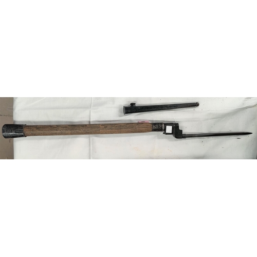 140 - An ENFIELD pattern spike bayonet with scabbard mounted on an ash handle for use as a mine probe 69cm... 